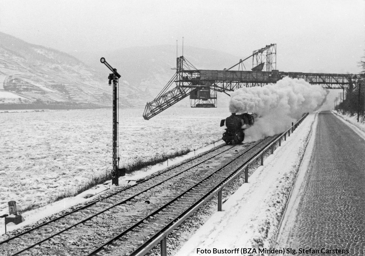 Eine Mischvorwärmer-52 sein mit einem nordwärts Güterzug im Februar 1956 an der Basaltverladeanlage der Hartsteinwerk-Grube Amalienhöhe bei Trechtinghausen